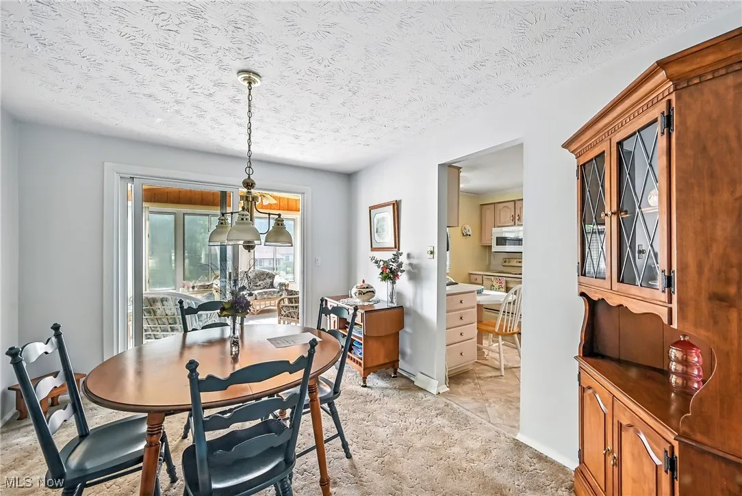 Dining space with a textured ceiling and baseboards