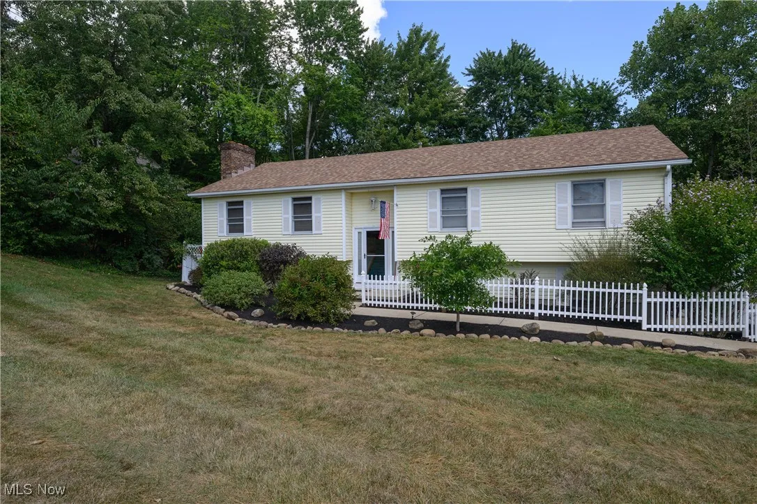 Bi-level home featuring a chimney