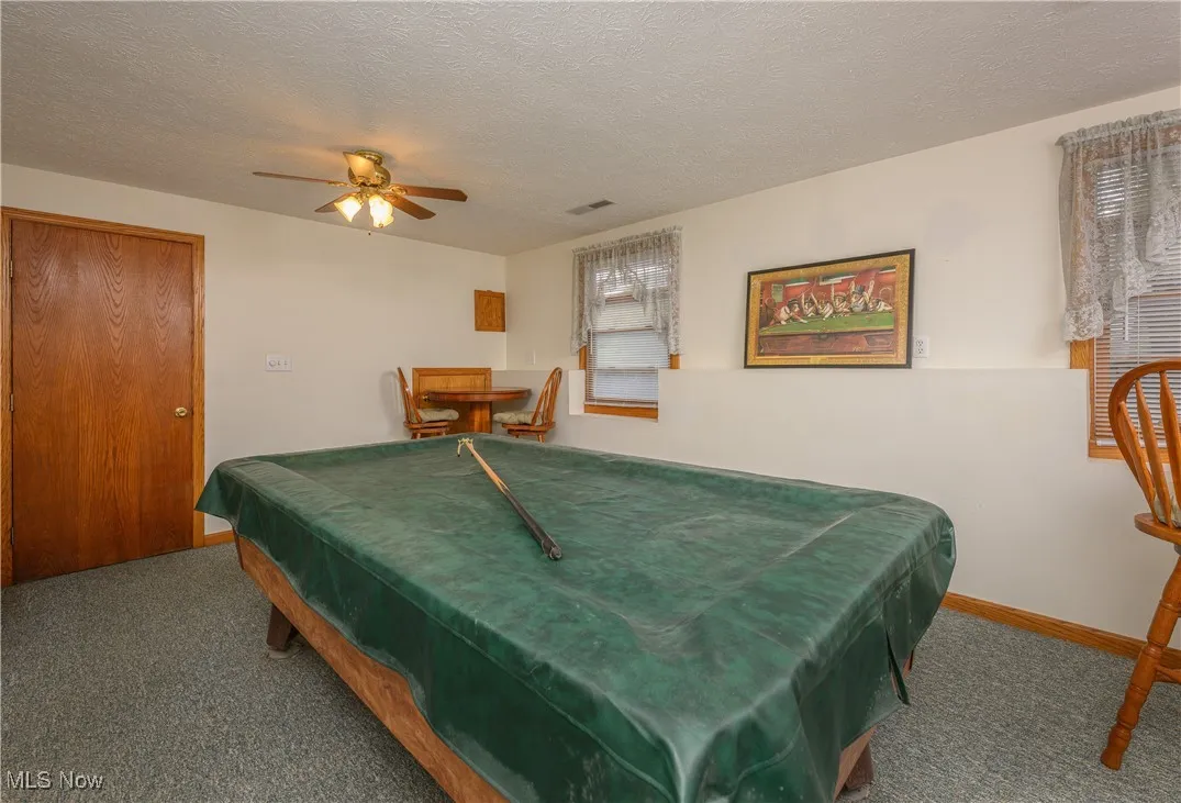 Bedroom featuring billiards table, a textured ceiling, carpet flooring, and ceiling fan