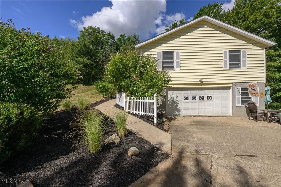 View of home's exterior with concrete driveway and a garage