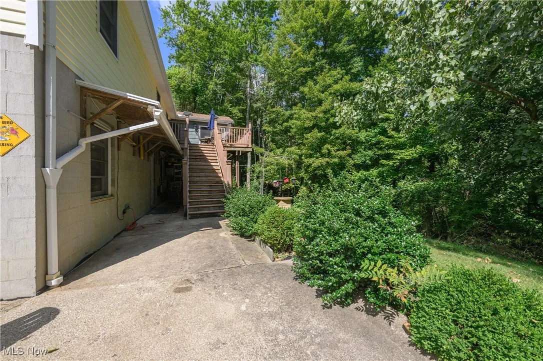 View of yard with stairway and a deck