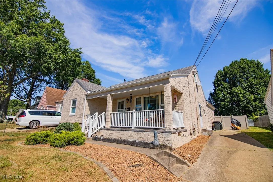 Bungalow-style house featuring covered porch and driveway