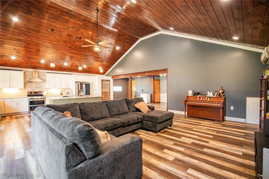 Living area featuring recessed lighting, wood ceiling, light wood-style floors, high vaulted ceiling, and a ceiling fan