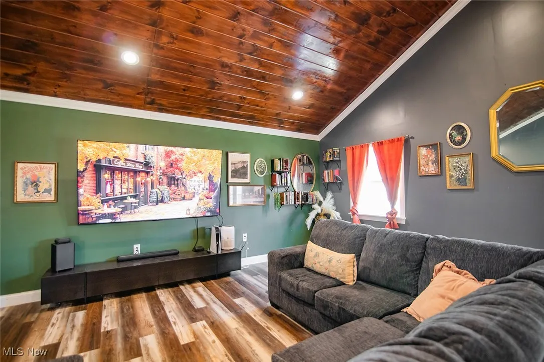Home theater featuring ornamental molding, lofted ceiling, wooden ceiling, wood finished floors, and recessed lighting