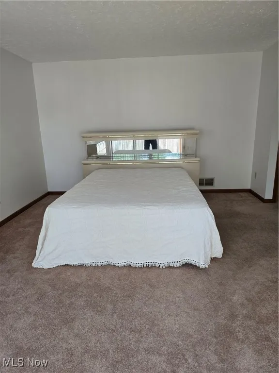 Master !st floor Bedroom featuring a vaulted ceiling and carpet floors
