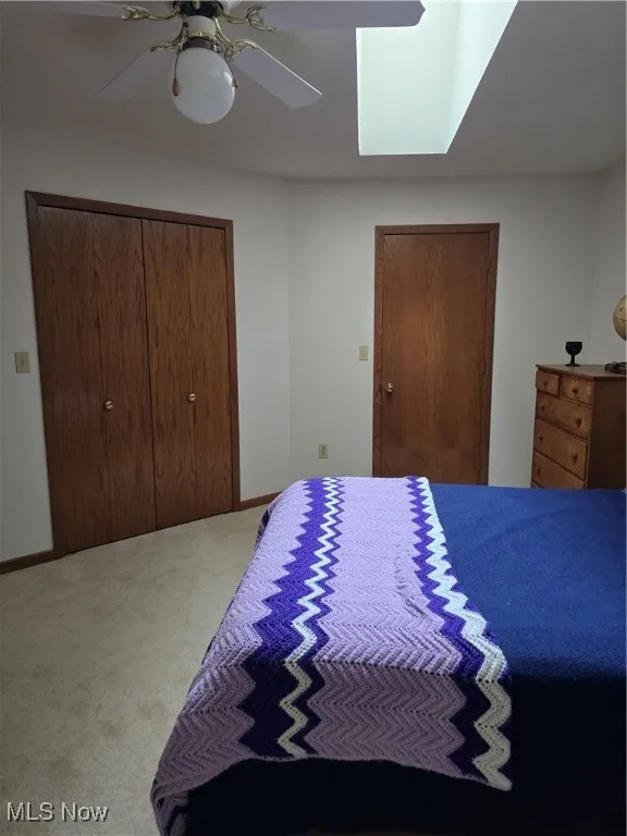 2nd Floor Bedroom featuring carpet floors, a ceiling fan, and multiple closets