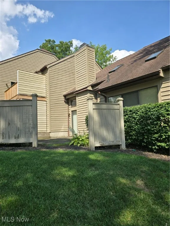 Rear view of condominium showing patio area