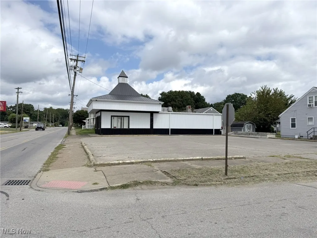 View of asphalt road with sidewalks and traffic signs