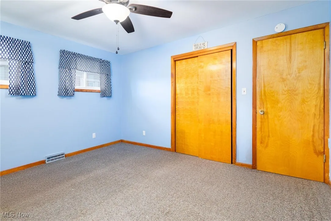 Unfurnished bedroom with carpet floors, a closet, and ceiling fan