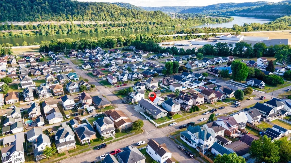 Aerial overview of property's location featuring a nearby body of water and nearby suburban area