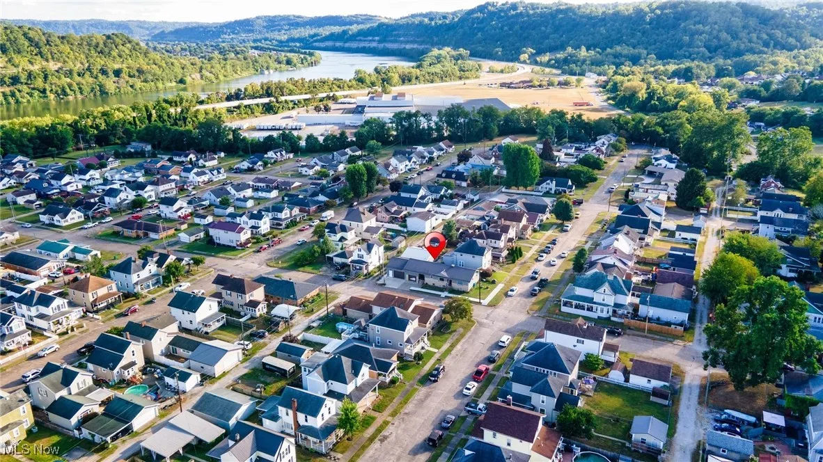 Aerial overview of property's location with a nearby body of water and nearby suburban area