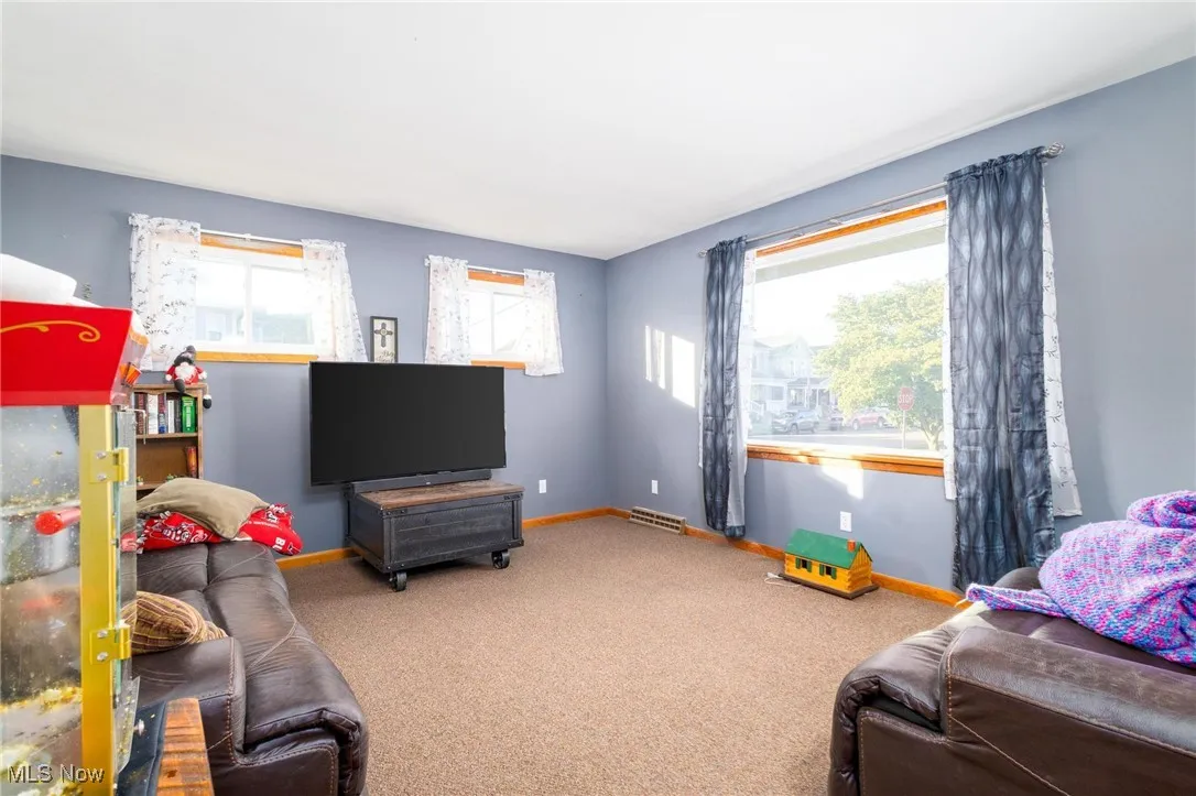 Carpeted living room featuring baseboards