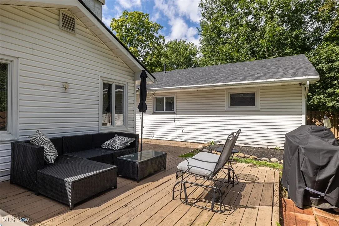 Wooden deck with an outdoor living space and grilling area