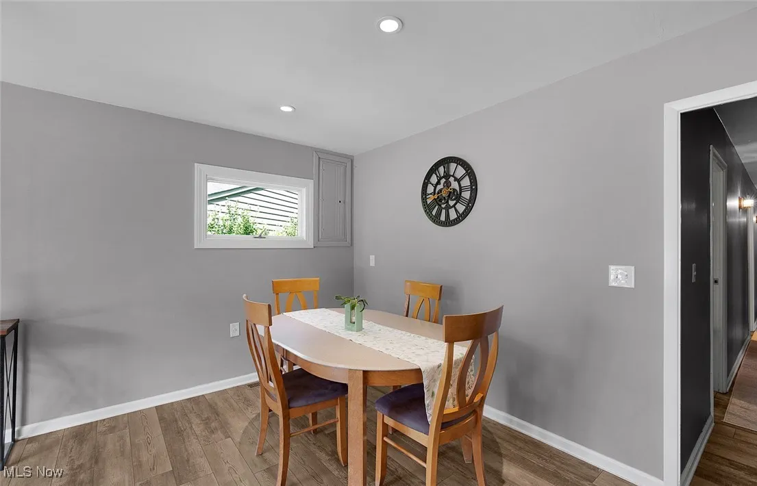 Dining room with vinyl plank floors and recessed lighting