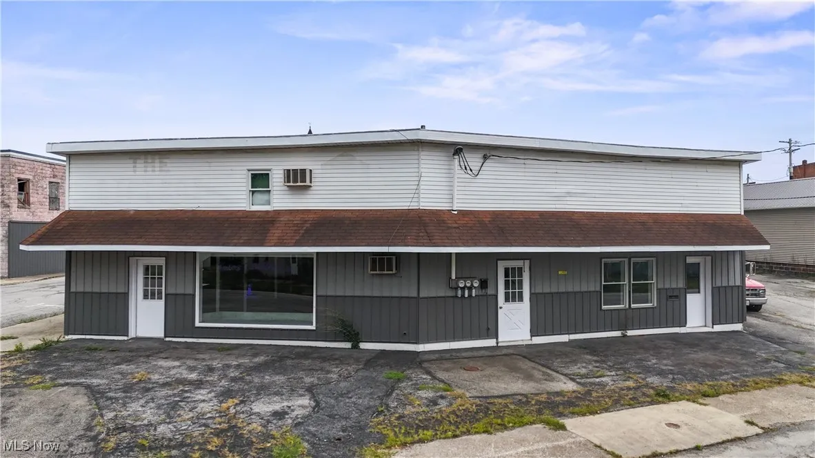 View of front of property featuring a shingled roof