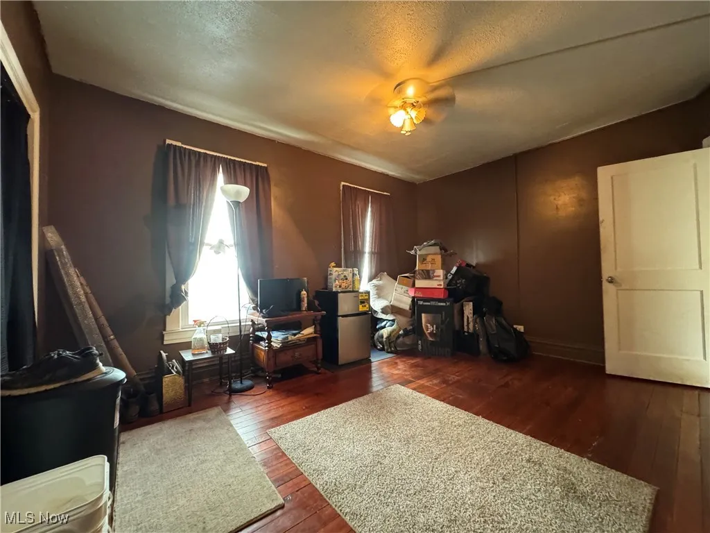 Office area with dark wood-style floors and a textured ceiling