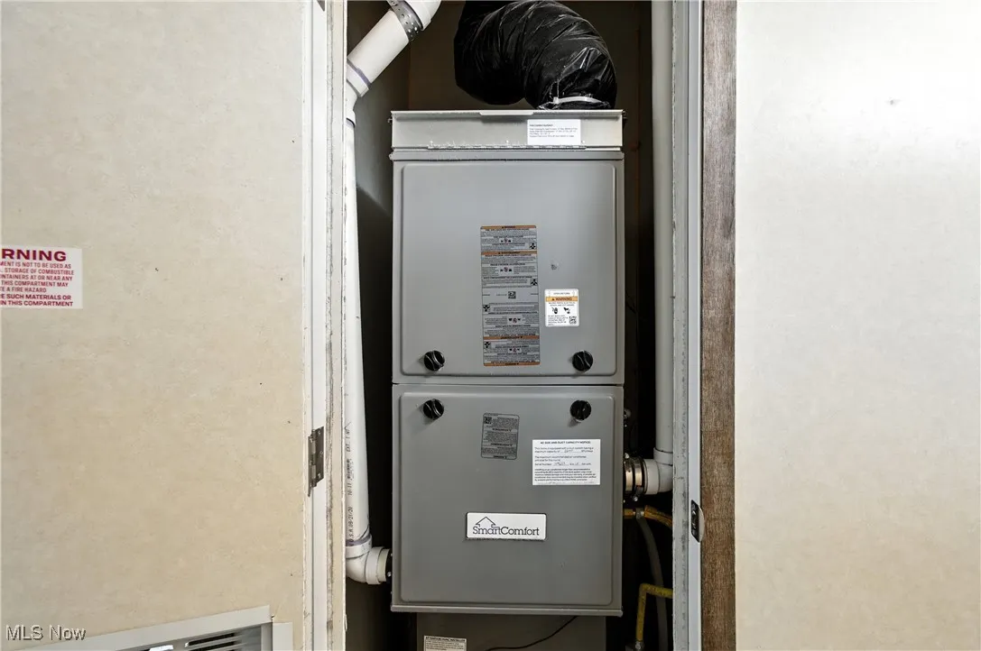 Utility room featuring heating unit