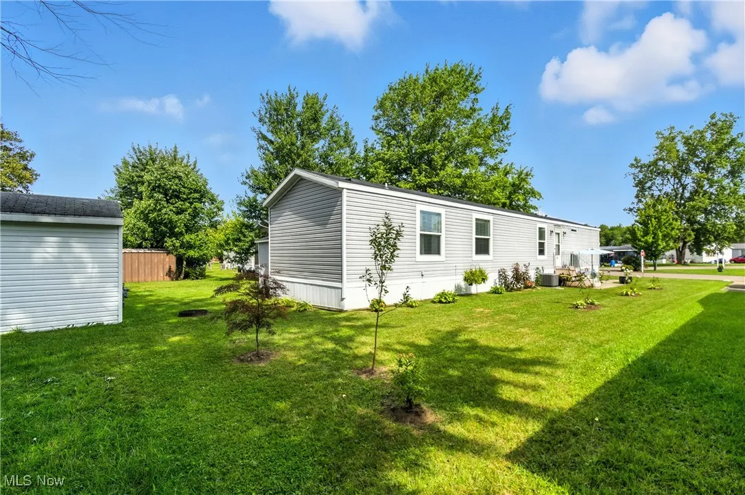 Rear view of house with a yard