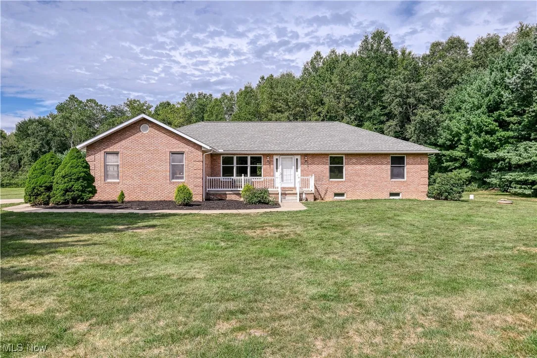 Ranch-style home with brick siding and a front lawn