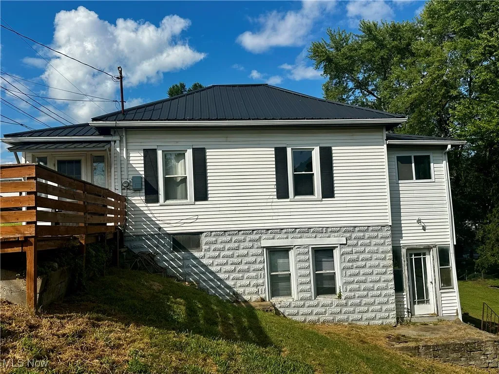 Side view of the home, showing the metal roof.