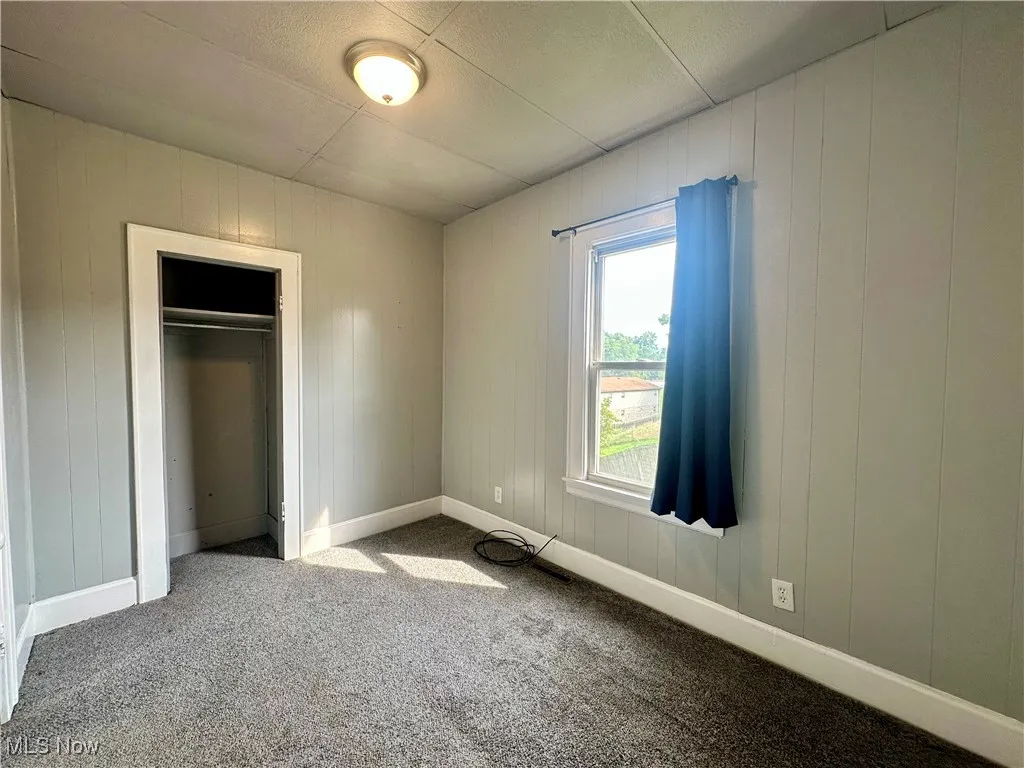 Second view of the first bedroom on the main floor, showing the closet.