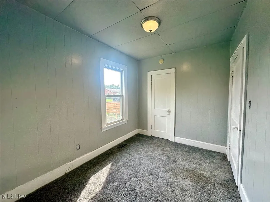 Additional view of the second bedroom on the main floor, showing the closet door.