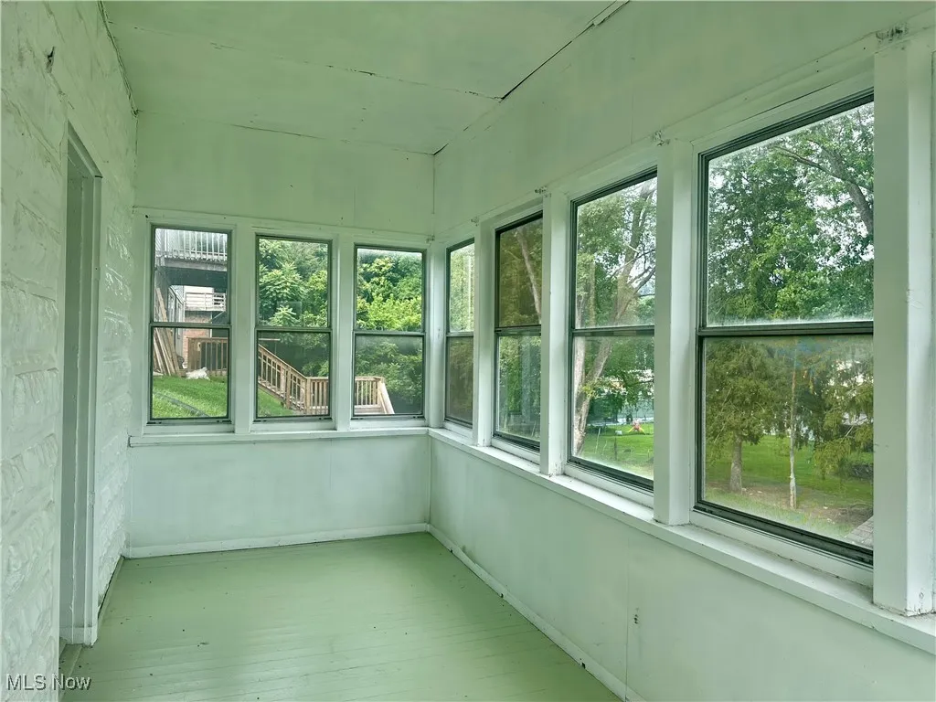 This sunroom on the lower level is just off the primary bedroom. The perfect place to start your day with a cup of coffee or unwind after a long day.