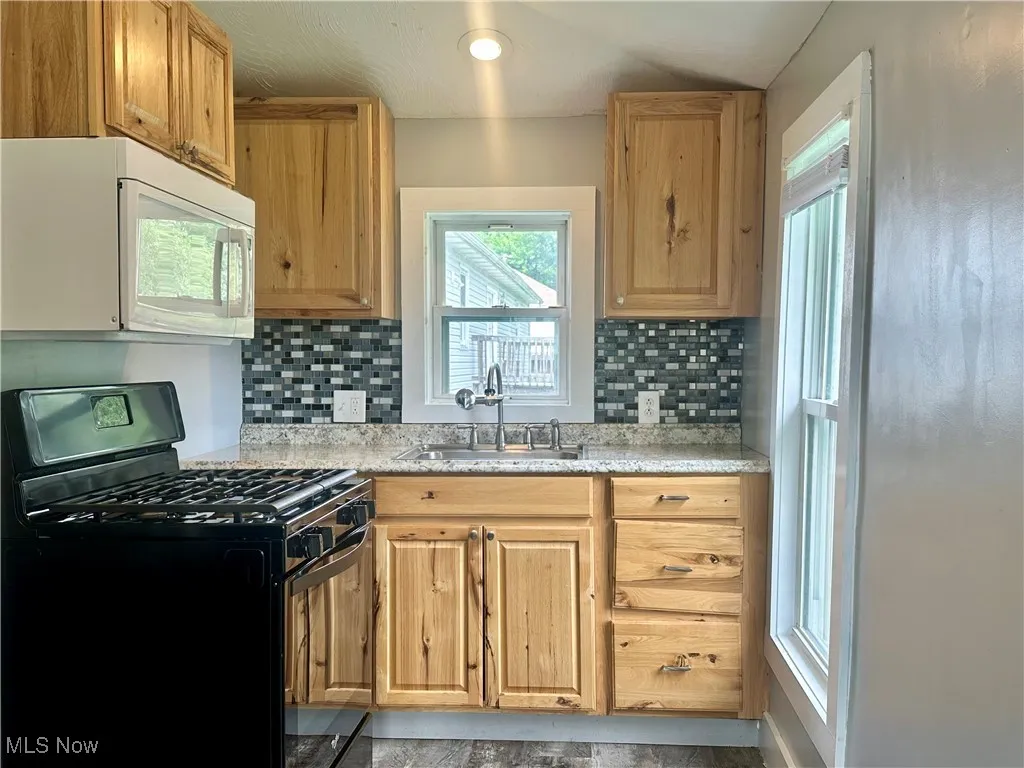 This cheery kitchen has lots of natural light flooding in through the windows.
