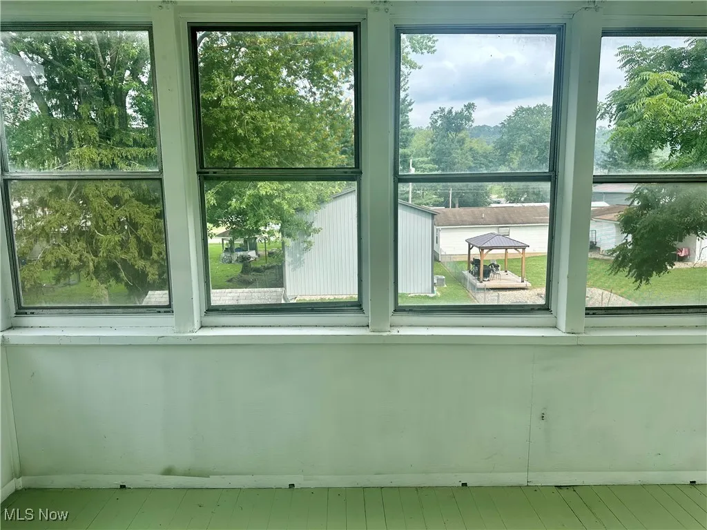 The lower level sunroom offers views of the large backyard.