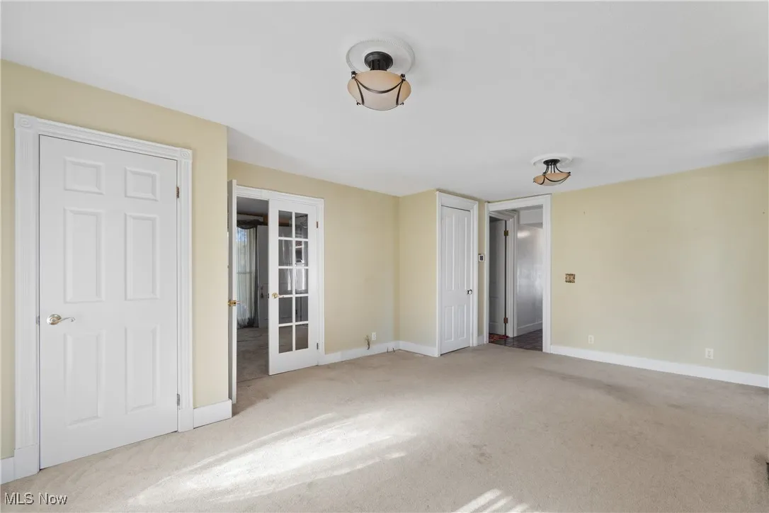 Unfurnished bedroom featuring carpet and baseboards