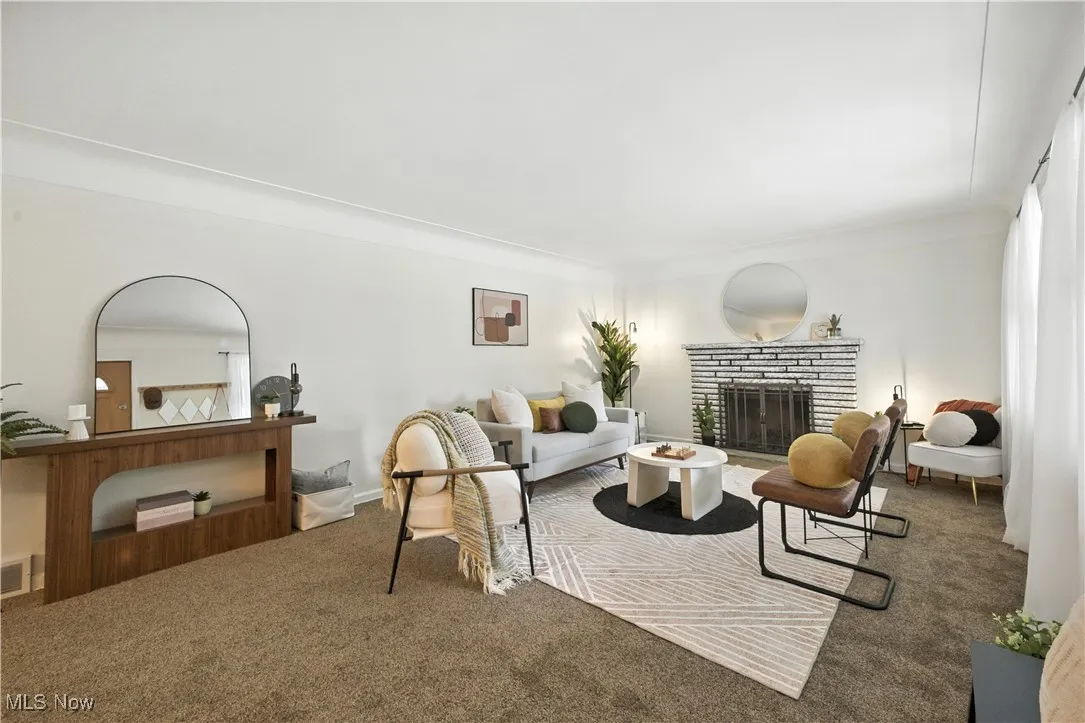 Carpeted living area with a fireplace