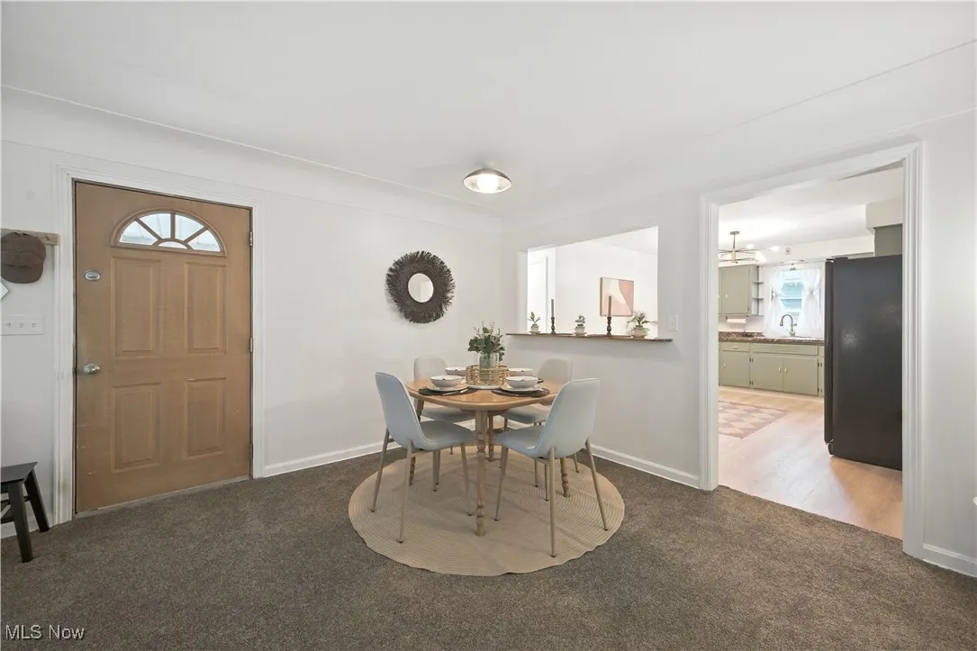 Dining space featuring dark carpet and baseboards