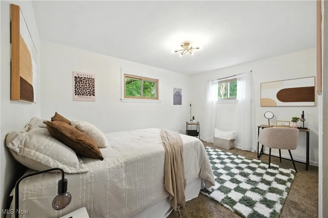Bedroom featuring carpet and baseboards