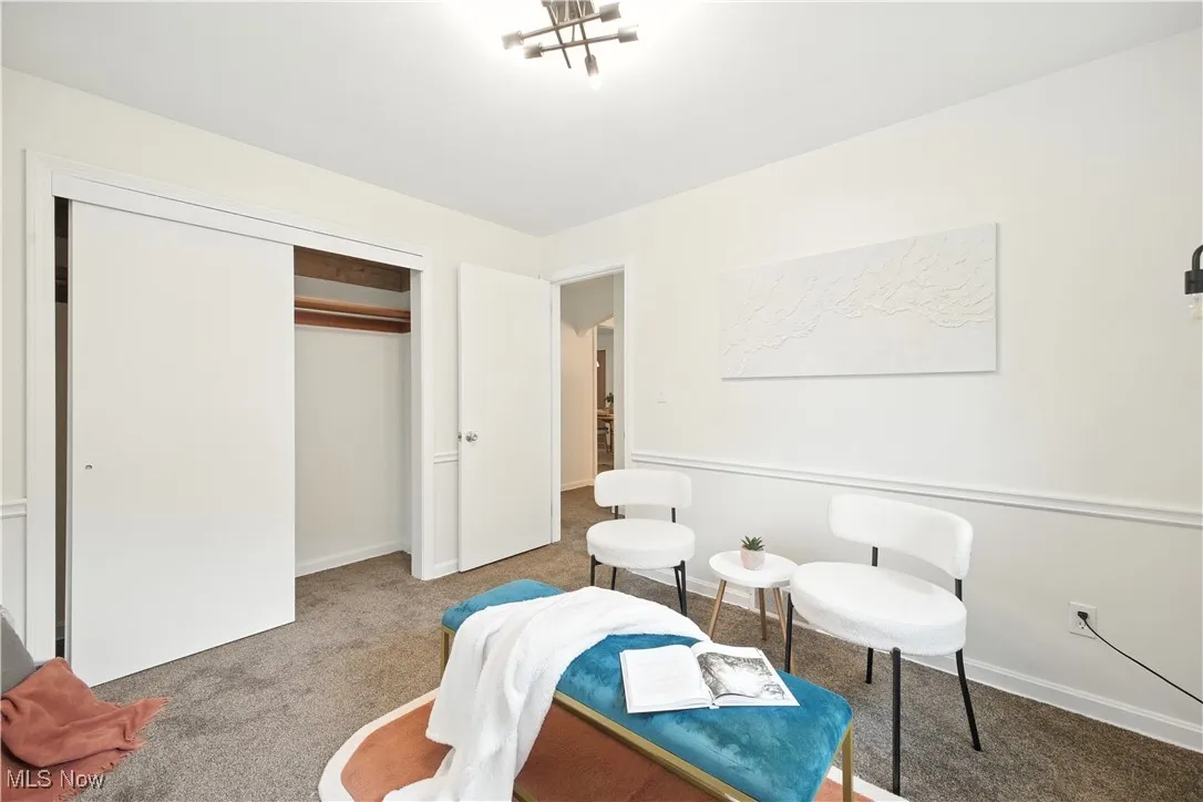Living area with carpet floors and baseboards