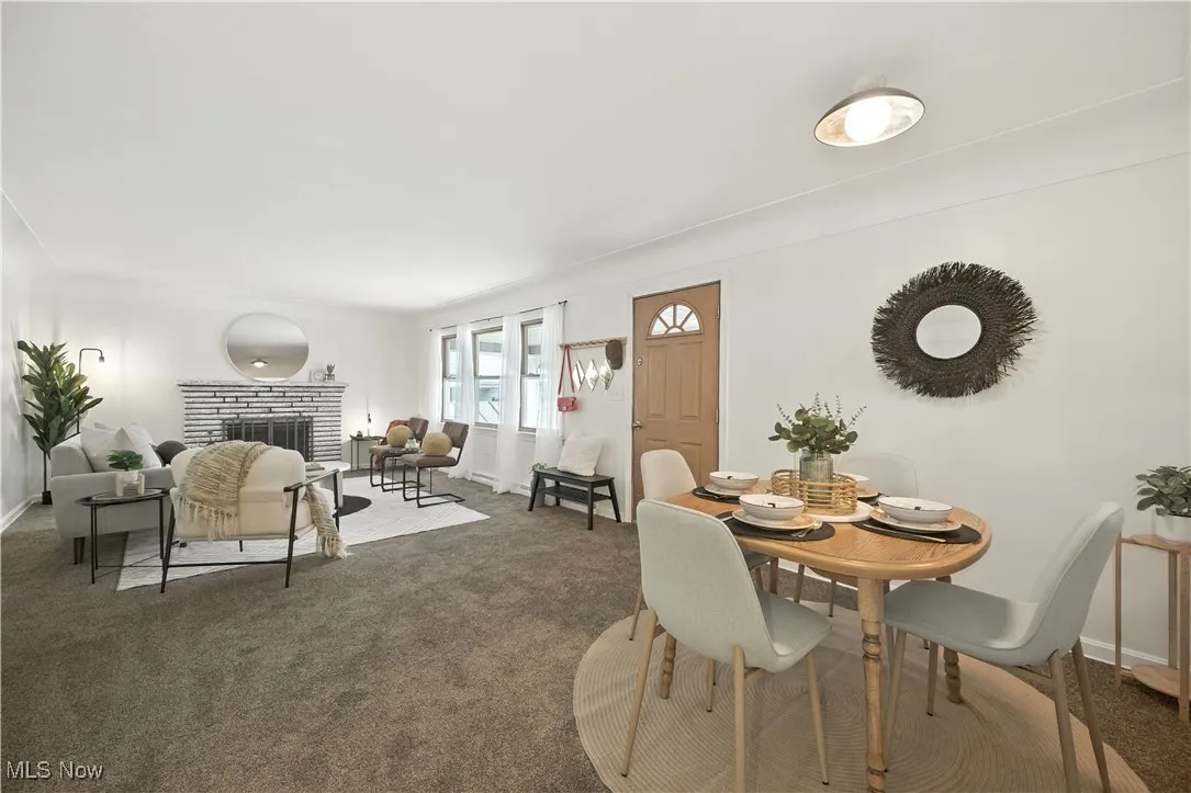Dining area with carpet flooring and a fireplace