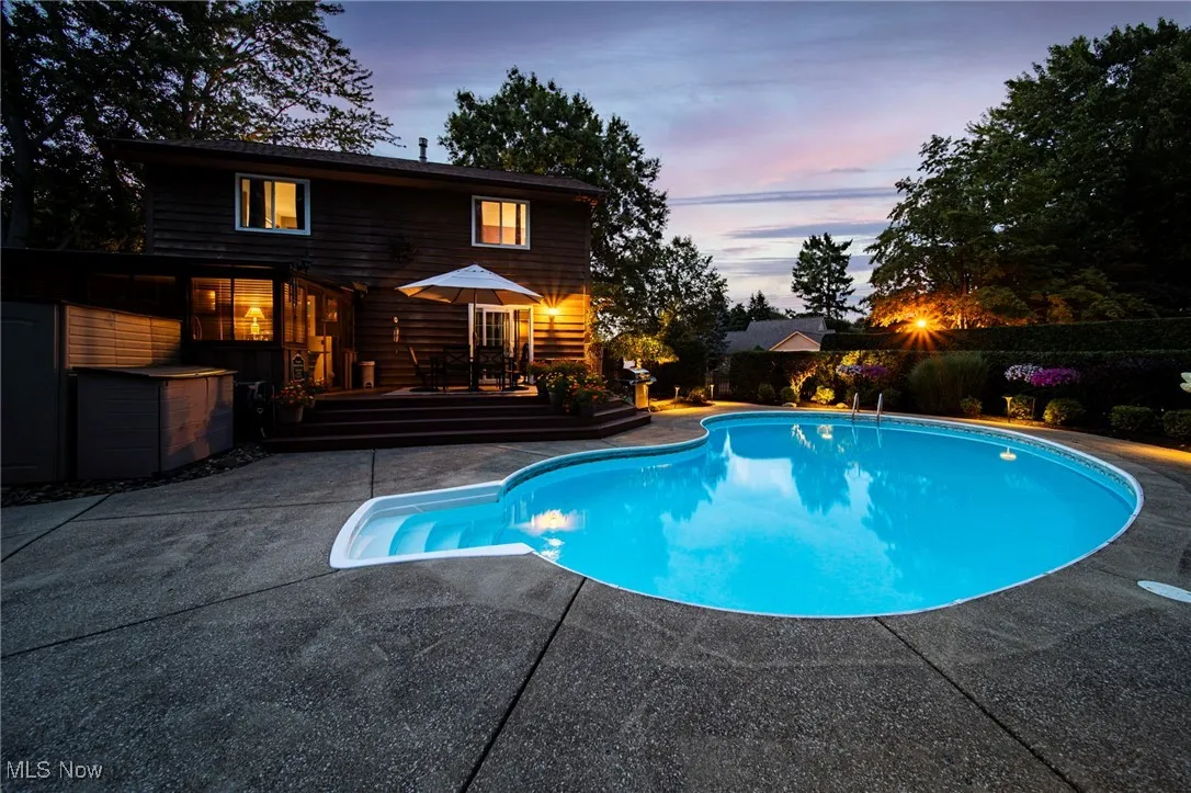 Pool at dusk with a patio