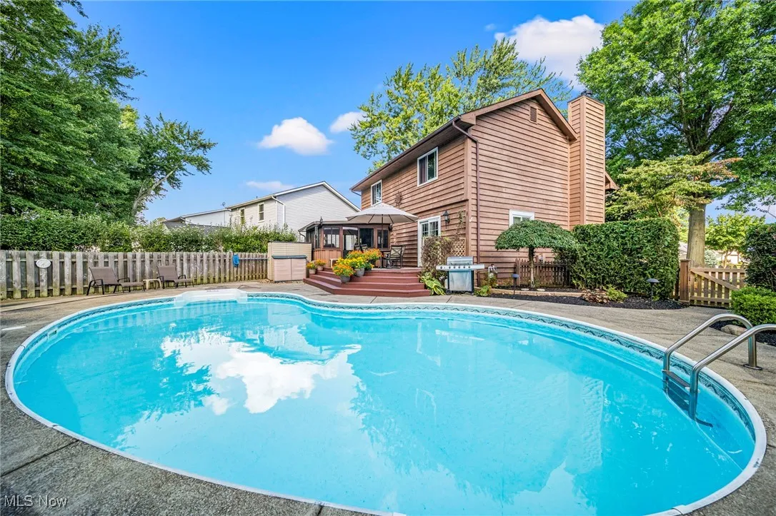 View of pool with a gazebo, a fenced backyard, a wooden deck, grilling area, and a patio