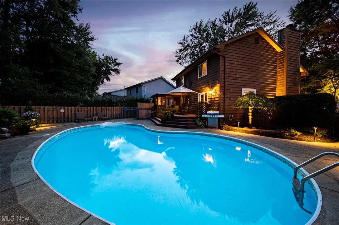 View of pool with a gazebo, grilling area, a deck, and a patio