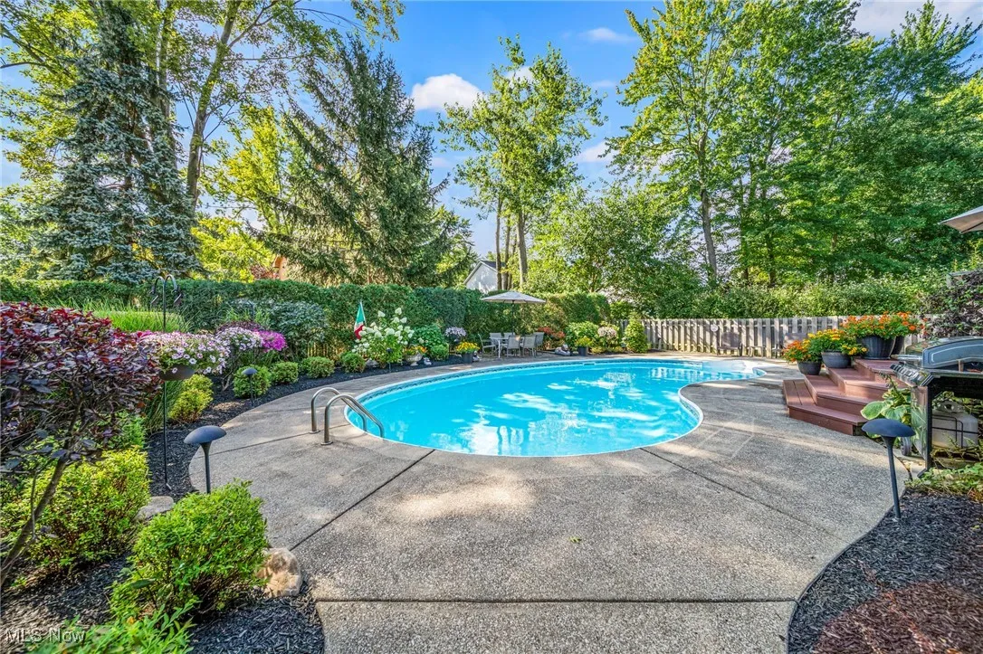 View of swimming pool featuring a patio area, a fenced backyard, and a deck