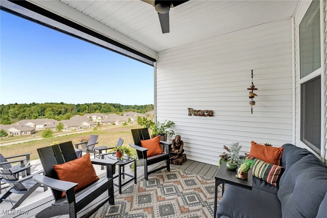 View of patio with a ceiling fan and a residential view