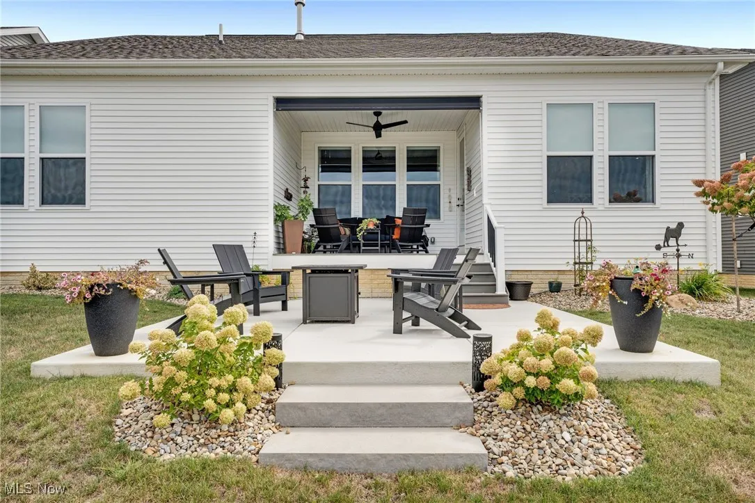 Back of house with a patio, ceiling fan, and roof with shingles