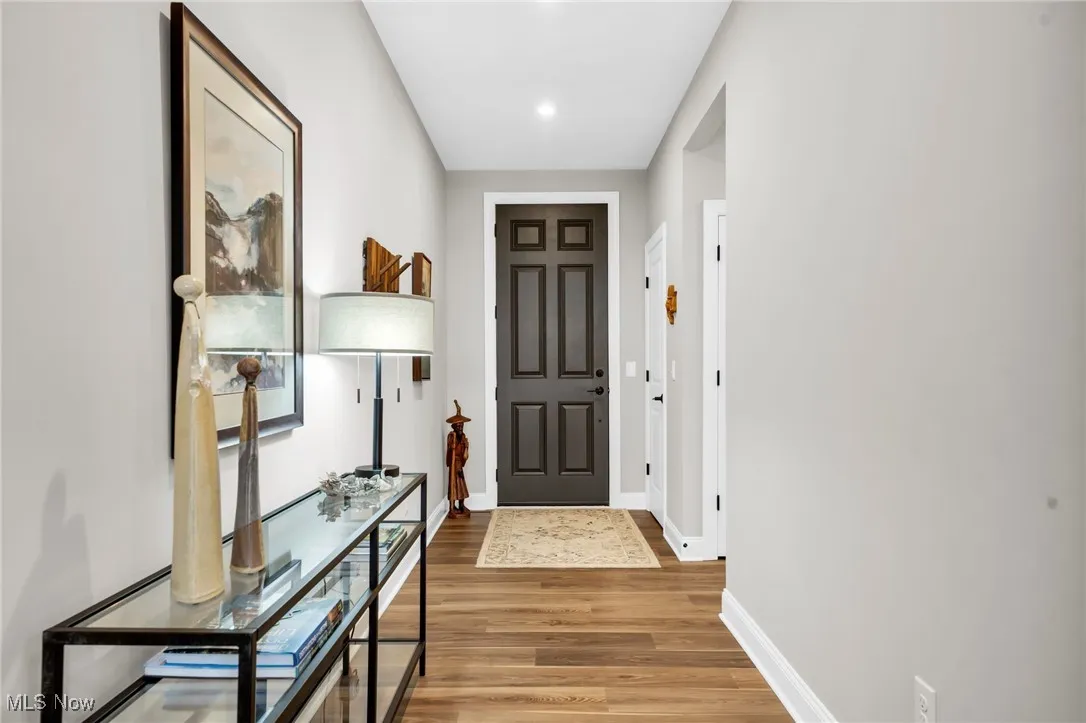 Entryway featuring wood finished floors and baseboards