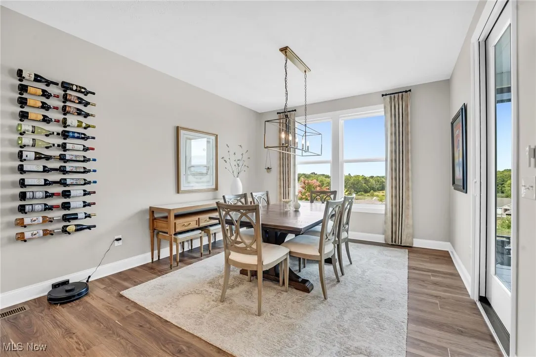 Dining room featuring wood finished floors and a chandelier