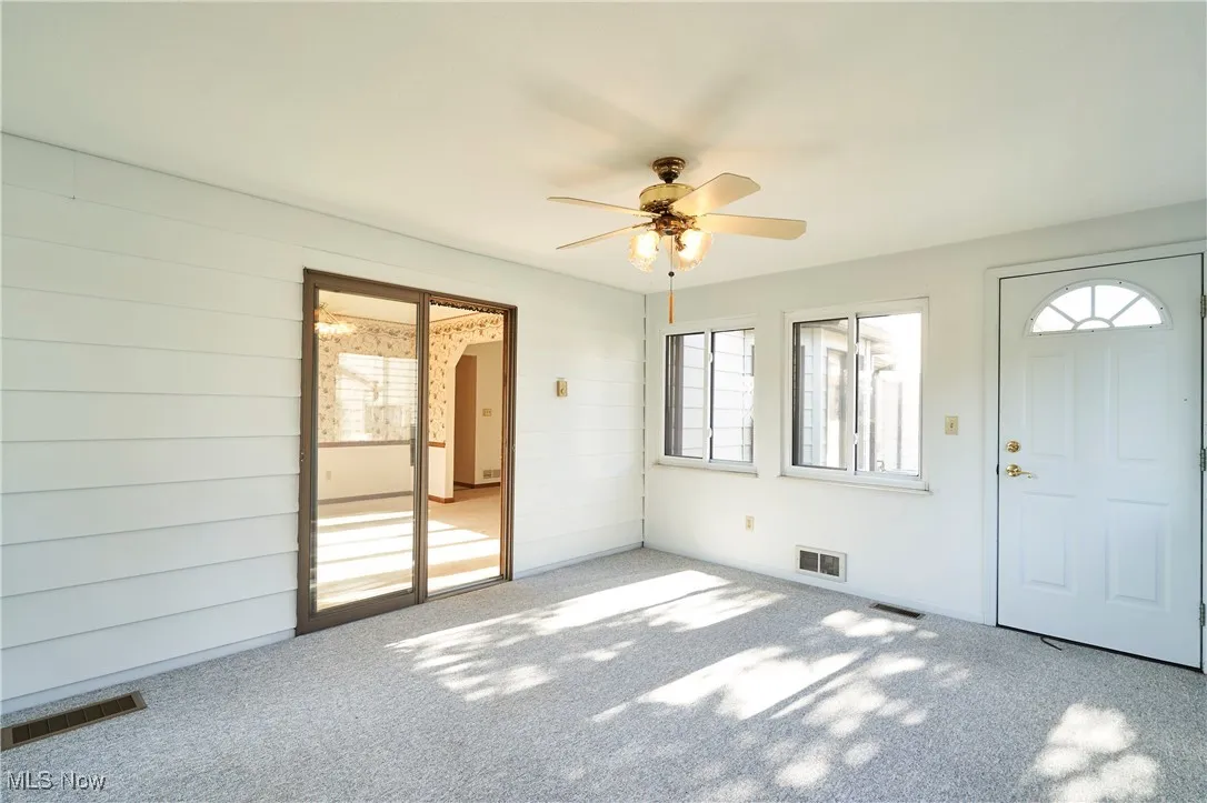 Sun porch access from Dining room and  exterior door leads ti back patio