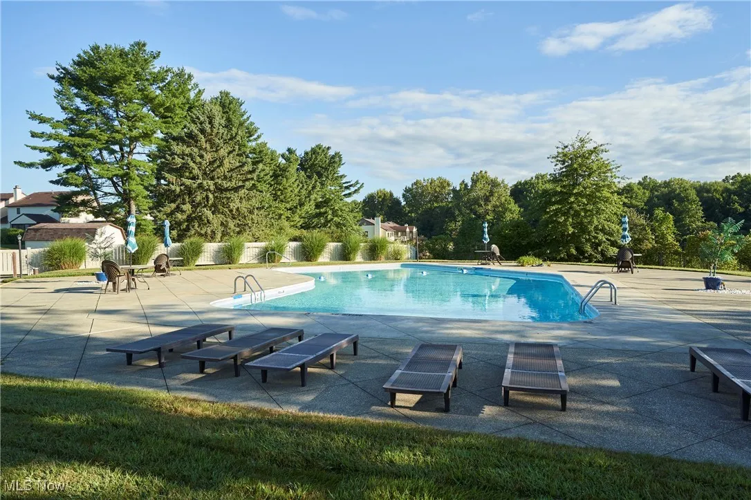 Community pool featuring a patio