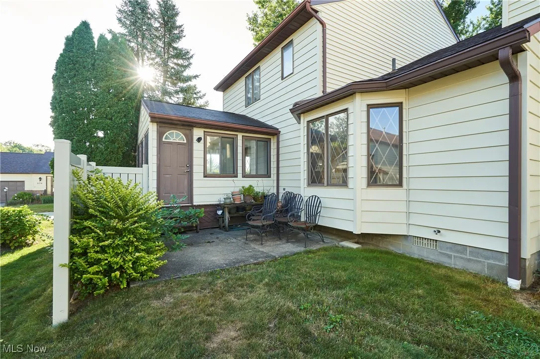 Rear view of property with a yard and a patio