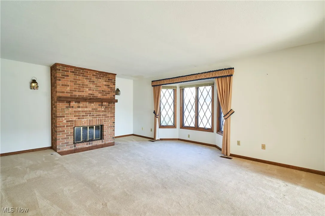 Living room with bayed window and fireplace.