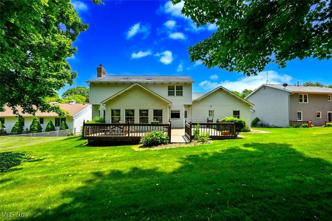 *BACK OF HOME SHOWING DECK AND LAND ~
