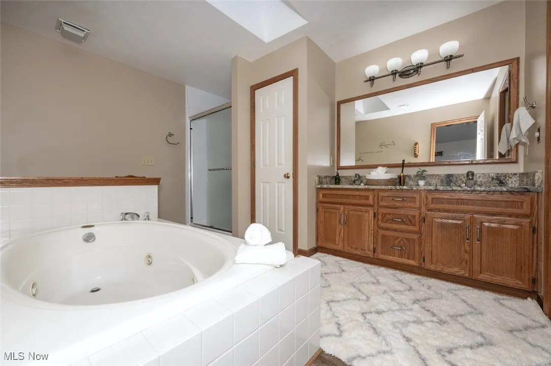 *MASTER ENSUITE FULL BATHROOM W/NEW LVP FLOORING, GRANITE COUNTERTOPS, HIS/HER SINK, SKYLIGHT, JETTED SUNKEN TUB, WALK IN SHOWER AND WALK IN CLOSET