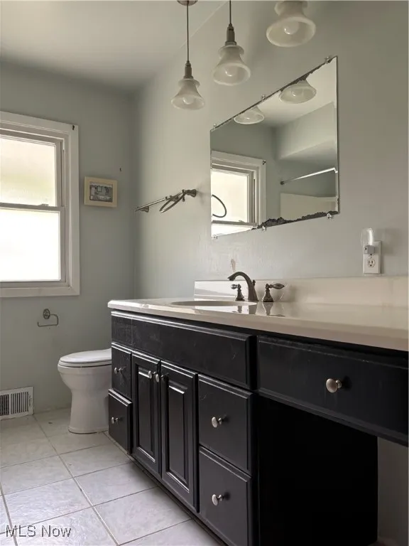 Bathroom with vanity and light tile patterned floors